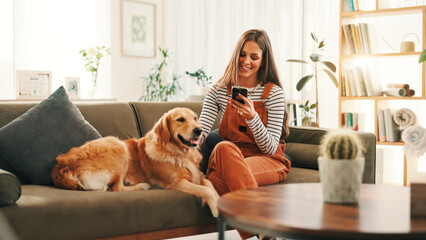 Smartphone, relax and woman on sofa with dog for bonding, reading or social media scroll at home on...