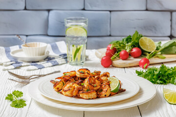 Grilled shrimp on a white plate with lime