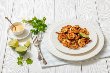 Grilled shrimp on a white plate with lime