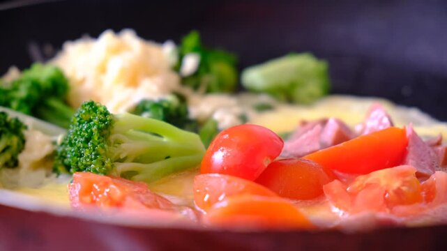 Stir-fried mixed vegetables and a fried egg on pan, healthy meal with vitamins and protein. Kind of Italian omelette with vegetables. Frittata