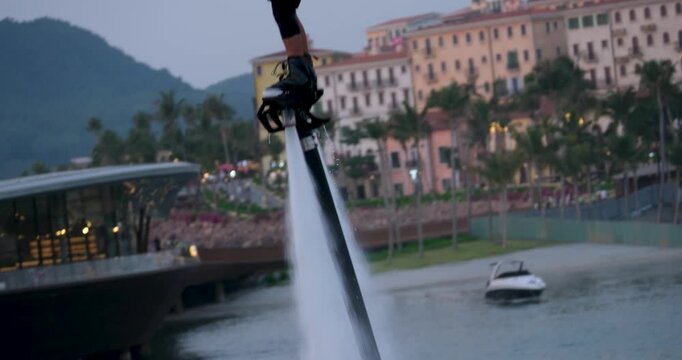 Vietnam Phu Quoc Island 04.04.2025 Bold Lady Flyboarding over River in Evening