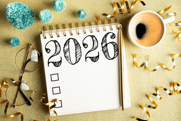 2026 New year resolutions on desk. 2026 goals list with notebook, coffee cup, festive decorations...