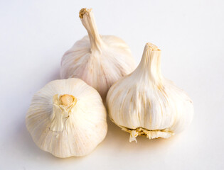 Garlic heads and cloves on white background