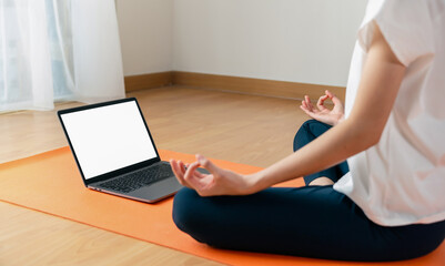 Woman doing exercise yoga plank and blank screen on laptop, for putting advertising to promote.
