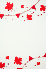Canada Day vertical background. Red maple leaves and triangle paper bunting garlands create top and...