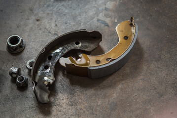 Drum brake and asbestos brake pads at car garage