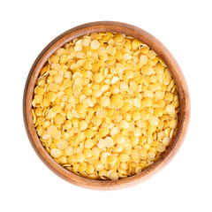 Yellow lentils in a wooden bowl. Dried seeds of a variety of Lens esculenta, a legume of small, round, and yellow in color fruits. High in protein and fiber, with soft and creamy texture, when cooked.