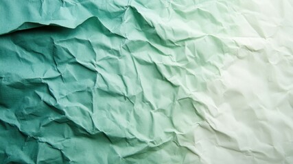 Obraz premium Abstract crumpled paper with a gradient of green to white, textured and wrinkled.