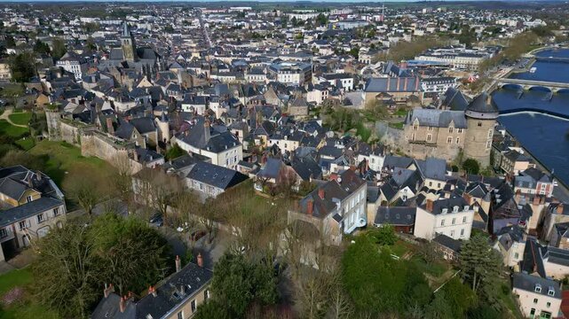 South Bastion and Cathedral of Sainte Trinit&eacute;, historic town center, Mayenne river, Laval city in France. Aerial drone forward