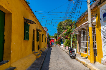 A view up a colourful backstreet in the Getsemani district of Cartagena, Columbia in springtime
