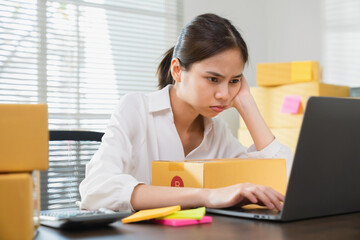 Small business, asian woman headache because there is a problem in management, delivery with packaging.