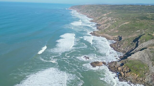 Rocky coastline with waves crashing near Miradouro do Salgado, Nazar&eacute;, Portugal