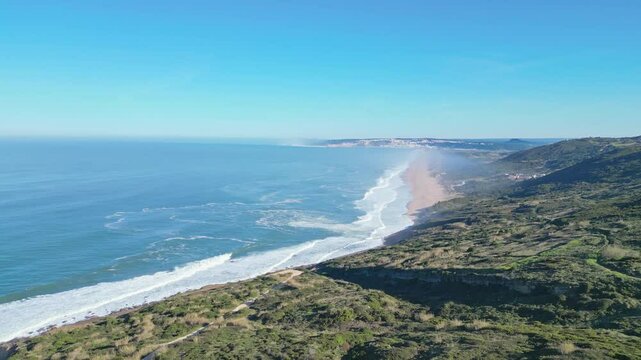 Sweeping aerial view of Miradouro do Salgado and coastline in Nazar&eacute;, Portugal