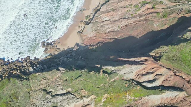 Rocky coastline view from above, Miraduro Da Salgado, waves crash below cliffs