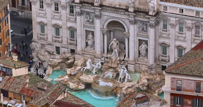 Aerial view of the Trevi Fountain, a tourist destination in Rome, Italy.Top view of the most famous fountain visited by tourists from all over the world. Drone ascends above Trevi Fountain