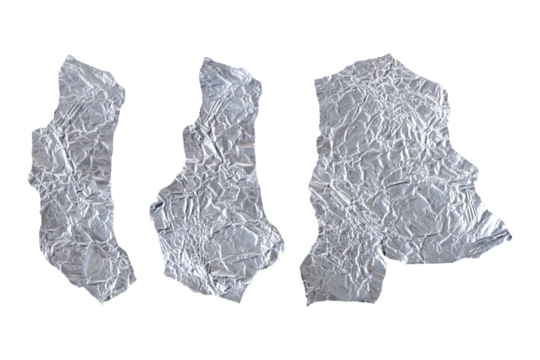 Three torn pieces of silver aluminum foil lie scattered against a clean white background. Their crumpled and irregular shapes catch light at various angles, creating bright highlights and deep shadows