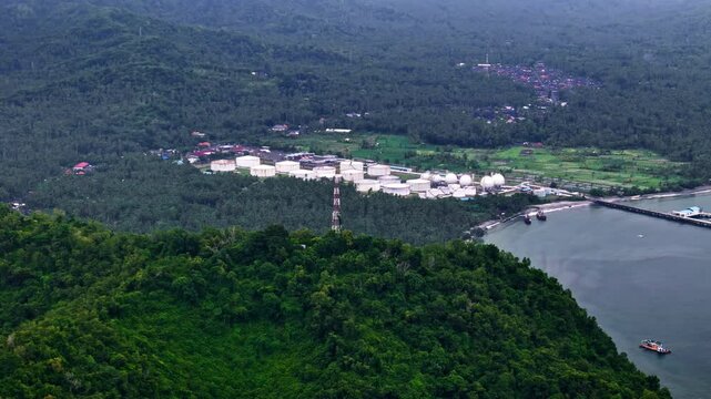Pertamina TBBM Manggis in Bali, set between lush green mountains and vibrant nature, blending industry with natural beauty.