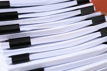 Binder clips with sheets of paper, closeup