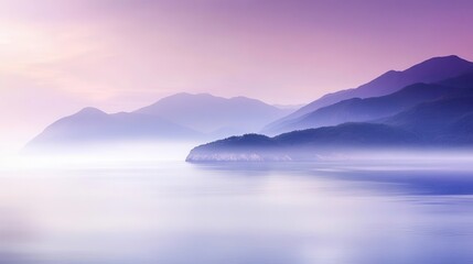 Misty purple sunrise over tranquil mountain ranges.