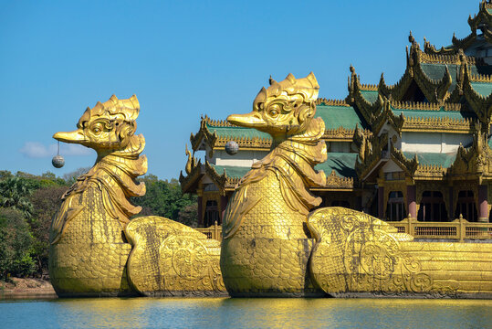 YANGON, MYANMAR - DECEMBER 18, 2016: Golden Dragon Heads. A fragment of a replica of the royal barge (floating restaurant). Yangon, Myanmar