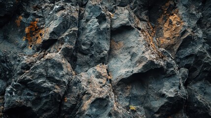 Fototapeta premium Dark, rough volcanic rock formations fill the image.