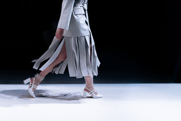 Fashion details of classic gray outfit and high heels shoes, women's fashion cloth concept on black...