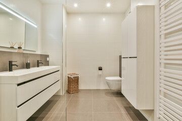 This bathroom features a sleek, minimalist design with clean lines, neutral colors, and contemporary fixtures, creating a serene and functional space.