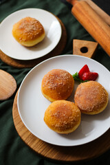 A handmade bombolone or bomboloni is an Italian-filled doughnut that is eaten as a snack or dessert. Selective focus.