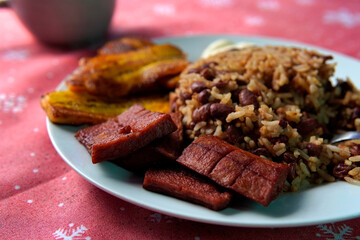 Traditional Costa Rican breakfast, rice and beans, called Gallo Pinto with eggs, tortilla, sausage...
