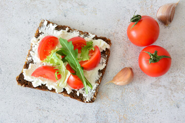 Sandwich with tomatoes, cheese and lettuce flat lay