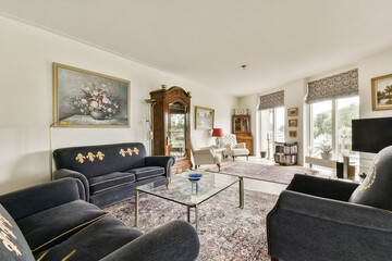 This stylish living room features plush furniture, tasteful decor, and ample natural light,...