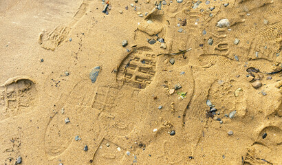 Footprints of many people in the sand.