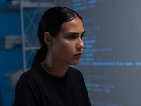 Young Hispanic Female software developer working on computer for coding software program in office. Focused Female programmer coding on desktop computer, programming, cyber security, web development. - Powered by Adobe