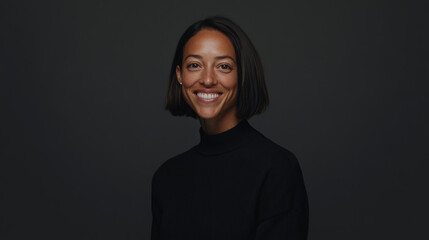 Confident middle-aged businesswoman with bob haircut, smiling openly in elegant gray-toned professional portrait.
