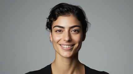 Portrait of a beautiful and confident woman with an open, sincere smile, minimalistic style, light colors, monochrome background