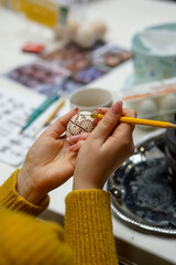 The process of painting Easter eggs, using bees wax as traditional Lithuanian method