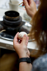 The process of painting Easter eggs, using bees wax as traditional Lithuanian method