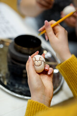The process of painting Easter eggs, using bees wax as traditional Lithuanian method