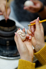 The process of painting Easter eggs, using bees wax as traditional Lithuanian method