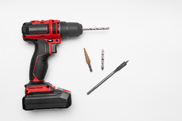 modern cordless screwdriver on a white background with a drill bit and accessories.