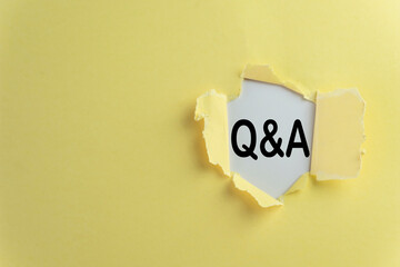 Yellow background with torn paper showing Q&A text use for Q&A(Question and answer),discussion,...
