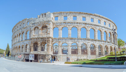 Fototapeta premium Pula Arena, ancient Roman amphitheater in Croatia, under blue sky