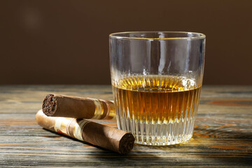 Whiskey in glass and cigars