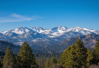 Serene Mountain Landscape with Snow-Capped Peaks and Evergreen Trees