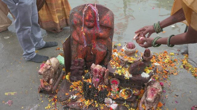 Ayodhya , India-4 January 2025 Hindu women worshiping Lord Hanuman on the banks of the Saryu River at Ayodhya Uttar Pradesh India