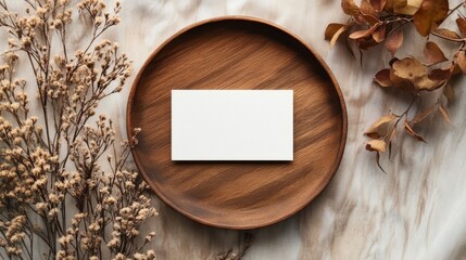 Clean minimal business card mockup on wooden plate with autumn plant.