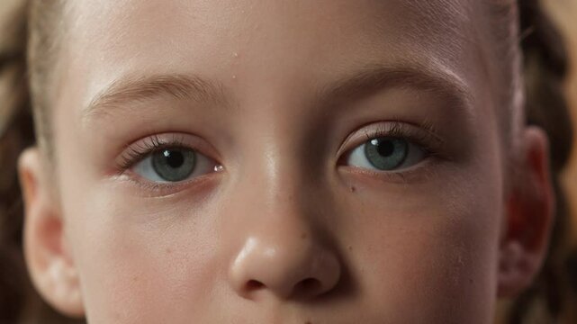 Cropped view child face serious close up eyes kid daughter little girl looking at camera healthy eye health look see indoors watching emotion toddler childhood custody adoption pediatric medicine