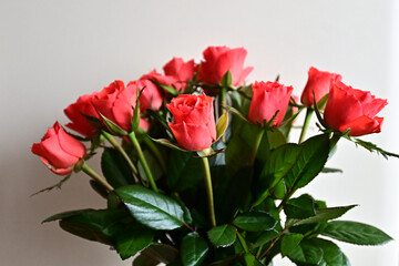 a bouquet of red roses in a vase on the table