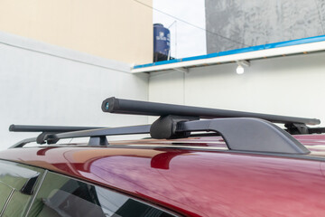 A roof rack on SUV car. A red car.