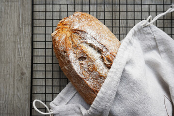 Freshly baked bread on a metal mesh tray